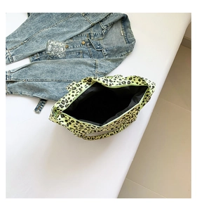 Detail of leopard print canvas tote bag with green base and spacious black interior lining