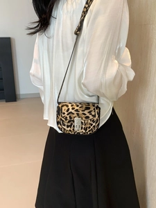 Stylish leopard print saddle bag with silver metal buckle and adjustable leather strap