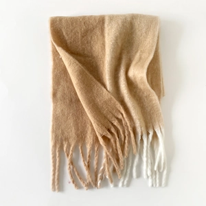 Detail of soft mohair scarf with beige and camel color block design and long fringes