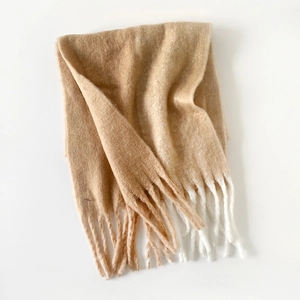 Detailed view of camel mohair knit scarf with long bicolor fringe edges for winter warmth