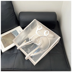 Large transparent PVC tote bag with white cartoon bear and cream leather inner pouch