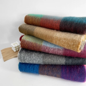 Detailed close-up of colorful rainbow plaid scarves showing soft mohair wool texture