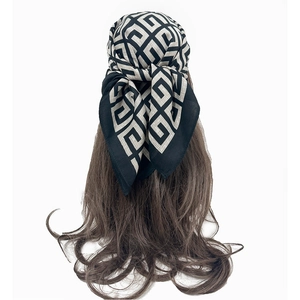 Detail showing the knotted back view of the paisley cotton scarf on brown hair