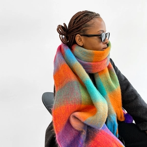 Close-up of vibrant rainbow checkered scarf showing thick fuzzy texture and plush fabric