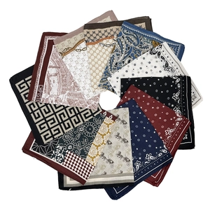Detailed overhead layout of assorted paisley and map print cotton linen square scarves