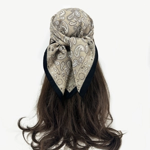 Back view of light brown paisley cotton linen headscarf tied on wavy long hair