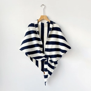 Detail of navy and white striped wool knit shawl showing soft texture and premium leather label