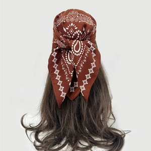 Brown paisley cotton bandana styled as a hair tie with vintage bohemian pattern detail