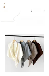 Detail showing high-quality wool-blend knitted shawl in four elegant earthy colors