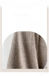 Detailed close-up of thick oatmeal knitted wool shawl showing soft ribbed texture