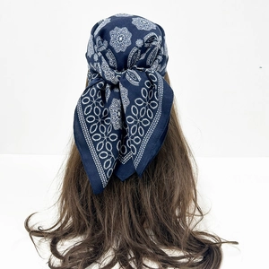 Deep blue paisley bandana tied on long hair showcasing retro bohemian style detail