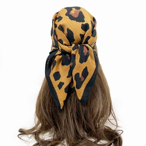 Close-up of leopard print cotton linen bandana showing the detailed knot tied at the back