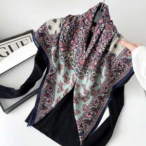 Close-up of lightweight paisley pattern silk scarf with retro red and navy floral prints
