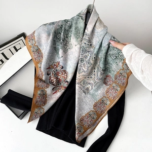 Detailed view of large paisley silk scarf with bohemian print and soft drape texture