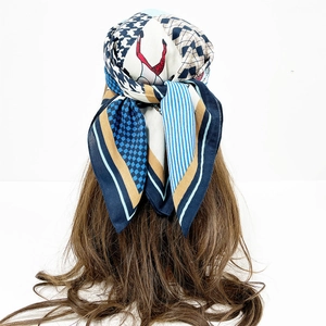 Detail view of paisley silk scarf featuring houndstooth and geometric patterns on hair