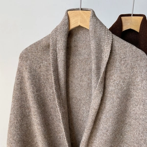 Oatmeal wool blend knitted shawl with shawl collar design on a wooden hanger