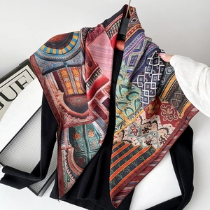 Detail of multi-color printed silk scarf with architectural and floral patterns on black fabric