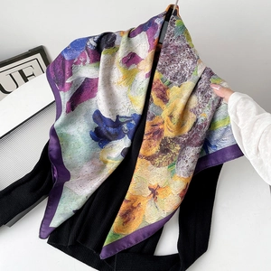Detail of oil painting floral silk scarf draped elegantly on a black sweater fabric