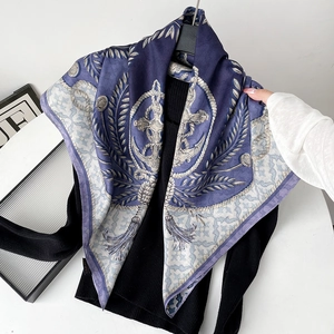 Detail of nautical silk scarf with anchors and ropes on a black knit background