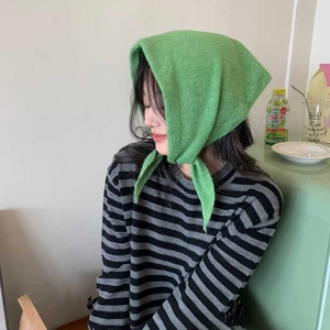 Détail d'un foulard capuche en maille verte avec de longs liens pour l'hiver