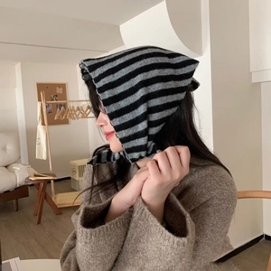 Détail d'un châle en tricot rayé avec capuche oreilles de chat en laine