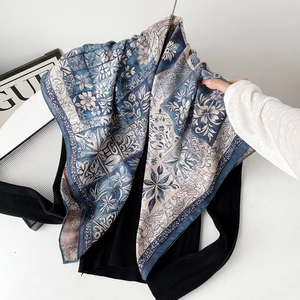 Detail of blue and beige silk scarf featuring vintage floral and mandala patterns