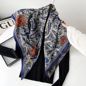 Close-up of silk wool square scarf featuring paisley and red rose floral patterns