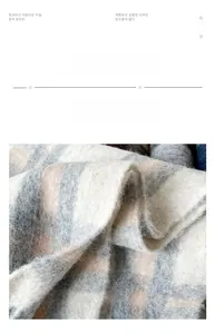 Close-up of thick plaid mohair scarf with fluffy brushed texture in grey and pink
