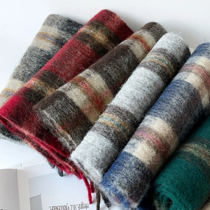 Close-up of thick brushed wool scarves with fringe details in multiple colors