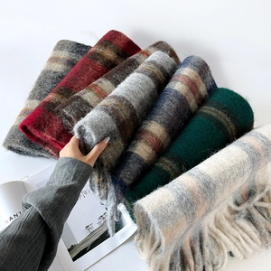 Detailed view of thick mohair plaid scarf with fluffy texture and long tassel edges