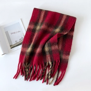 Macro detail of red and black plaid mohair scarf texture with fringed tassel edges