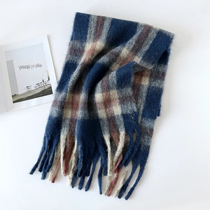 Detailed view of thick plaid mohair scarf with blue and beige check and long tassels