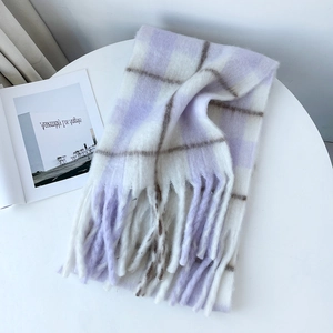 Detailed close-up of soft purple and white plaid mohair scarf with fluffy fringe edges