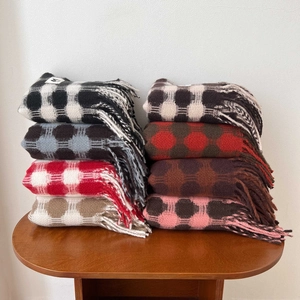 Detailed macro view of heavy brushed plaid scarves with long tassels in various patterns