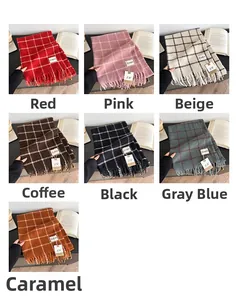 Detail view of plaid scarves in red, pink, beige, and gray with fringe tassels