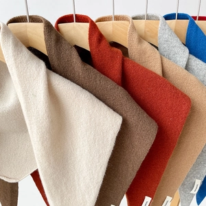 Detail view of 100% pure wool knitted triangle scarves in multiple color options