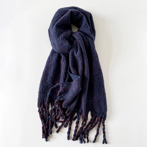 Detailed view of dark blue and reddish-brown striped wool scarf with soft fringe edges