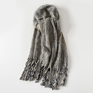 Close-up of off-white wool scarf with navy vertical stripes and chunky tassels
