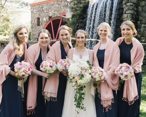 Detail of light pink cashmere-feel scarf featuring delicate fringe for bridesmaids