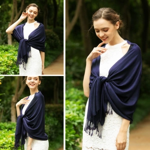 Elegant navy blue tassel shawl pashmina styled with a white lace dress in a garden