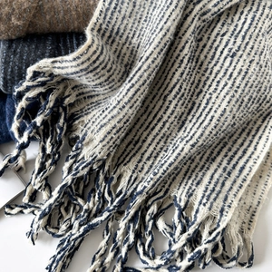 Soft wool knit scarf for women featuring cream and navy blue stripes with fringe details