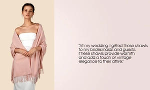 Detail of light pink cashmere-feel scarf with elegant fringes draped on shoulder