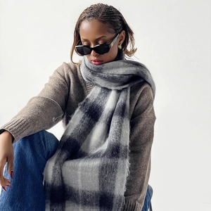 Close-up of thick plaid mohair scarf with fluffy texture and grey checkerboard pattern