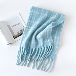 Close-up of soft plaid mohair scarf with fringes and elegant magazine background