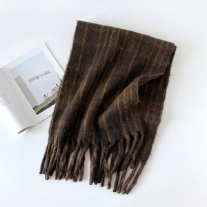 Detailed view of dark brown striped wool scarf with soft tassels and plush texture