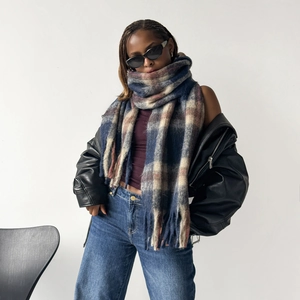 Detailed view of heavy wool-touch plaid scarf with fringe tassels in check patterns