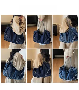 Detail shot of large denim tote bag featuring metal buckles and chain straps in two colors