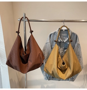 Close-up of hobo bag textures in brown and mustard with retro bead details