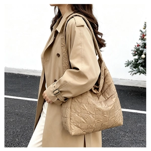 Detailed side view of khaki quilted tote bag featuring a soft puff woven texture and broad strap