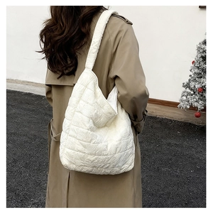 Spacious quilted tote bag shown on model, highlighting its soft texture and large capacity